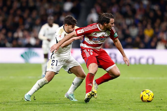 Archivo - El defensa del Granada Ignasi Miquel protege el balón ante el delantero del Real Madrid Brahim Díaz, en el encuentro de LaLiga EA Sports 2023-2024 disputado en el Santiago Bernabéu.