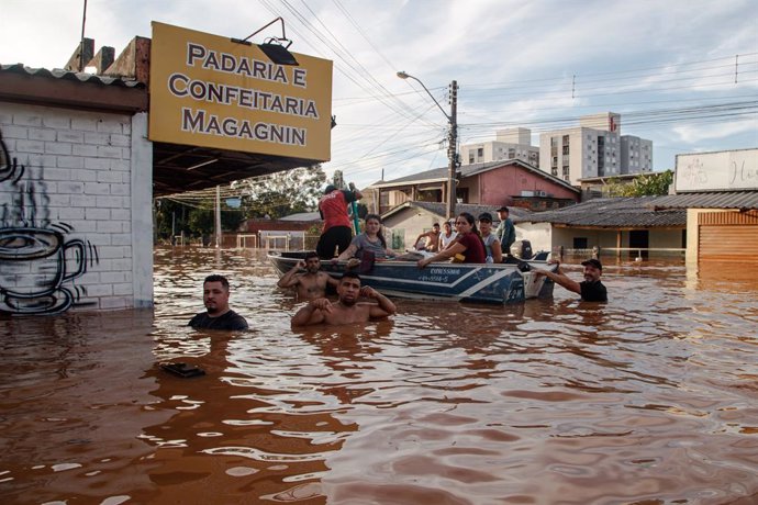 SCHARLAU, May 8, 2024  -- A rescue team evacuate flood-affected people in Santo Afonso, Novo Hamburgo, in the state of Rio Grande do Sul, Brazil, on May 7, 2024. Five more people were killed by storms ravaging south Brazil's Rio Grande do Sul state in the