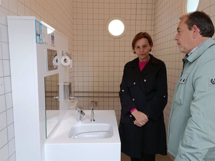 La alcaldesa de Gijón, Carmen Moriyón (Foro), en el primer baño adaptado para ostomizados en espacio municipal gijonés, en la playa de Poniente, junto al presidente de la asociación de Ostomizados del Principado de Asturias, Fermín Montes.