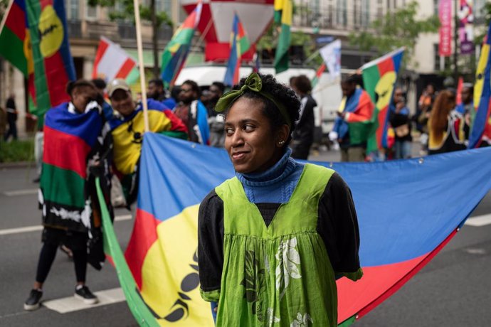 May 1, 2024, Paris, France: Protestors hold a flag of French territory New Caledonia during the annual May Day demonstration.. Annual May Day protests saw more than 120,000 march throughout France with a large gathering in Paris resulting in clashes betwe