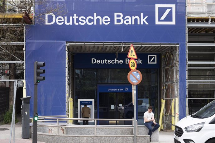 April 6, 2024, Madrid, Spain: A man sits in front of the German investment bank and financial services Deutsche Bank branch in Spain.