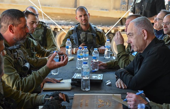 HANDOUT - 16 May 2024, ---: Israel's Prime Minister Benjamin Netanyahu speaks with soldiers after an aerial tour over the Gaza Strip. Photo: -/GPO/dpa - ATTENTION: editorial use only and only if the credit mentioned above is referenced in full