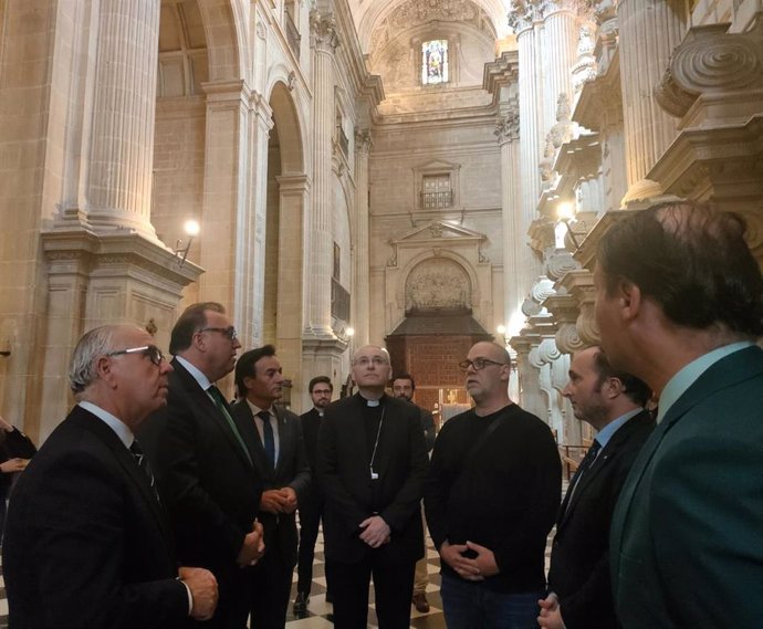 Representantes de la Junta, el Ayuntamiento y el Obispado atienden las explicaciones del maestro vidriero (3d) sobre la restauración.