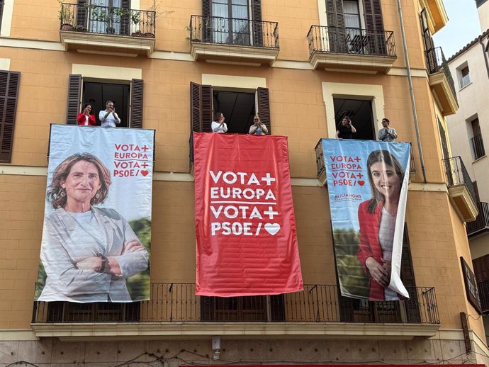 Despliegue de carteles de cara al 9J en la fachada del PSIB-PSOE, en Palma.
