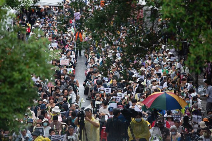 May 24, 2024, Taipei, Taiwan: Protesters sit on ground while holding placards expressing their opinion outside the Legislative Yuan during the demonstration. Thousands of demonstrators gathered outside of the parliament to protest against the controvers