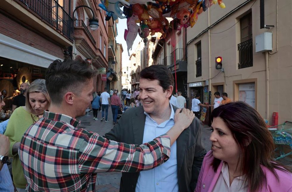 El presidente del PP de Castilla y León, Alfonso Fernández Mañueco, saluda a un vecino en Benavente.