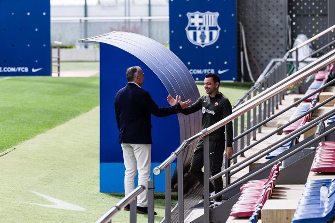 Xavi Hernandez, head coach saludates to Rafa Yuste sports vice president of FC Barcelona during the training session of FC Barcelona before the spanish La Liga EA Sports football match against Sevilla FC at Ciudad Esportriva Joan Gamper on May 25, 2024 in