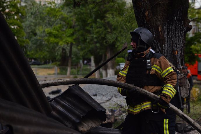 May 14, 2024, Kharkiv, Kharkiv Oblast, Ukraine: Fire crews work to extinguish a fire following a Russian strike. Residents and fire crews work to clean up following a Russian strike.