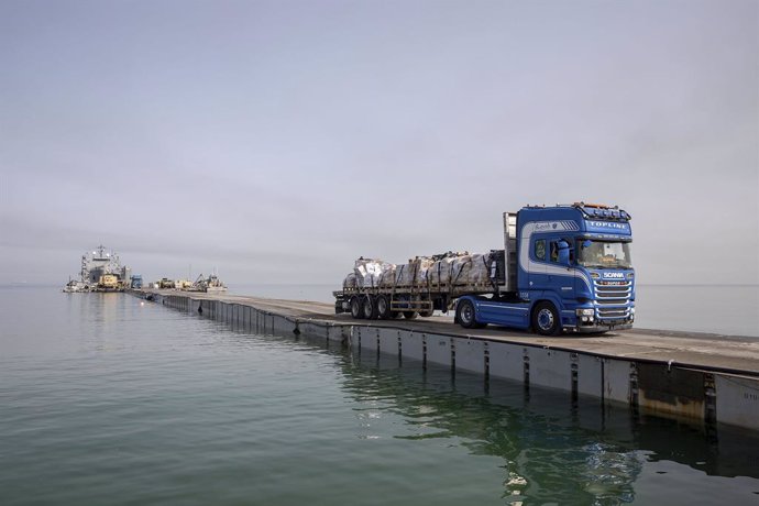 May 19, 2024, Mediterranean Sea, Gaza, Israel: Trucks loaded with humanitarian aid across the Trident Floating Pier on the Mediterranean Sea, May 19, 2024, in Gaza, Palestinian Territory. The floating pier will be used to move humanitarian aid directly fr