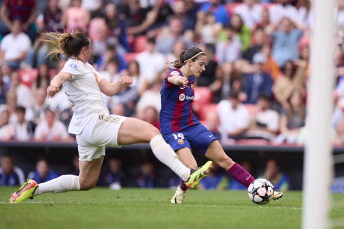 Aitana Bonmati of FC Barcelona competeixes for the ball with Alice Marquis of Olympique Lyonnais during the UEFA Women's Champions League 2023/24 Final match between FC Barcelona and Olympique Lyonnais at San Mamis on May 25, 2024, in Bilbao, Spain.