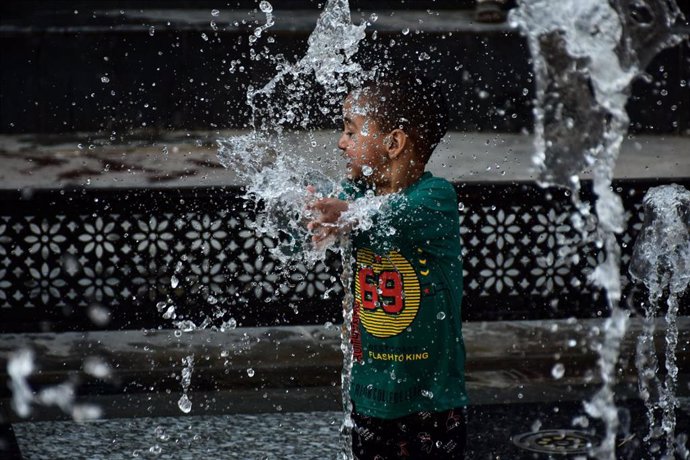 Un niño se refresca por la ola de calor en Srinagar