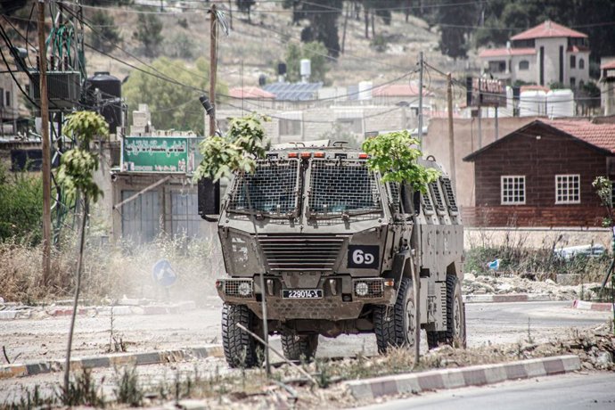 May 22, 2024, Jenin, West Bank, Palestine: An Israeli military vehicle blocks the entrance to Palestinian Jenin refugee camp during the ongoing mission for the second day in a row, in the northern West Bank. Eyewitnesses reported that the number of people