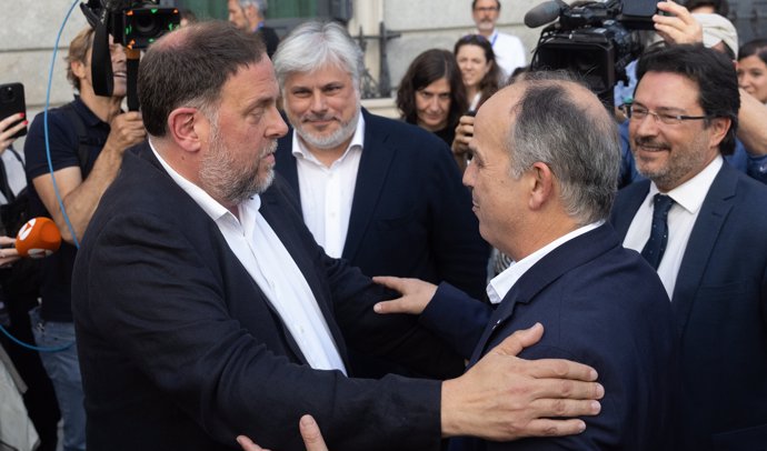 El presidente de ERC, Oriol Junqueras (i) y el secretario general de Junts, Jordi Turull (d), se abrazan tras quedar aprobada la Ley de Amnistía, en el Congreso de los Diputados, a 30 de mayo de 2024, en Madrid (España).