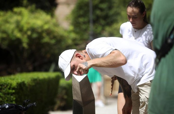 Archivo - Un hombre bebe agua de una fuente en una imagen de archivo 