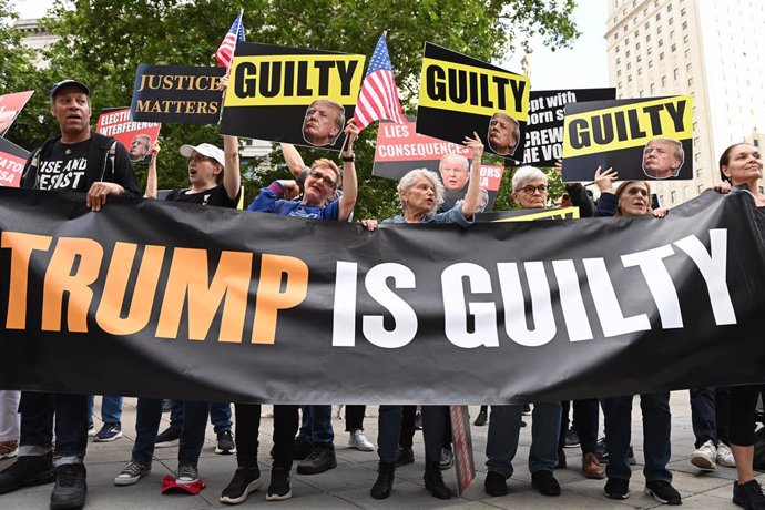 30 May 2024, US, New York: Anti-Trump protesters hold posters and banners after jury in New York on 30 May found Donald Trump guilty of falsifying business records in a trial over the concealment of hush money payments in the run-up to the 2016 election, 