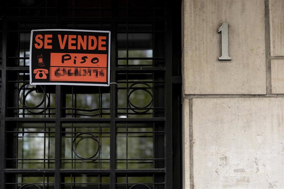 Archivo - Vista de un cartel de 'Se vende piso' en un portal de un edificio