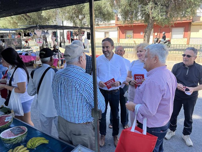 El secretario general del PSOE de Málaga, Daniel Pérez, y el secretario general de la agrupación de Churriana, Salvador Trujillo, en un reparto electoral en el mercadillo