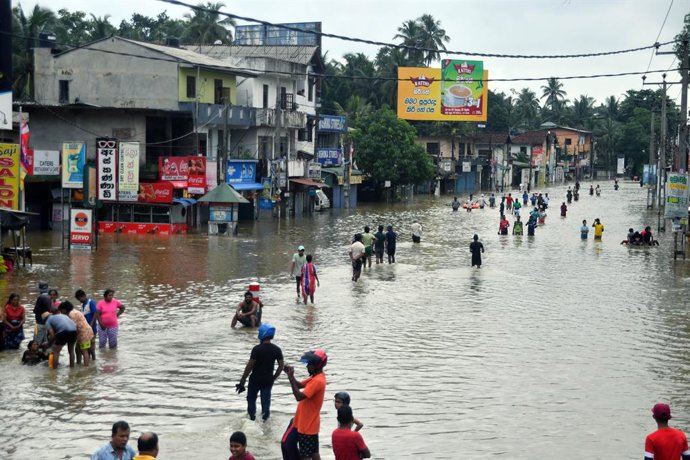 COLOMBO, June 3, 2024  -- Residents wade through a flooded street after heavy rains on the outskirts of Colombo, Sri Lanka, on June 3, 2024. Sri Lanka's Disaster Management Center (DMC) issued a major flood alert in the outskirts of capital Colombo and se