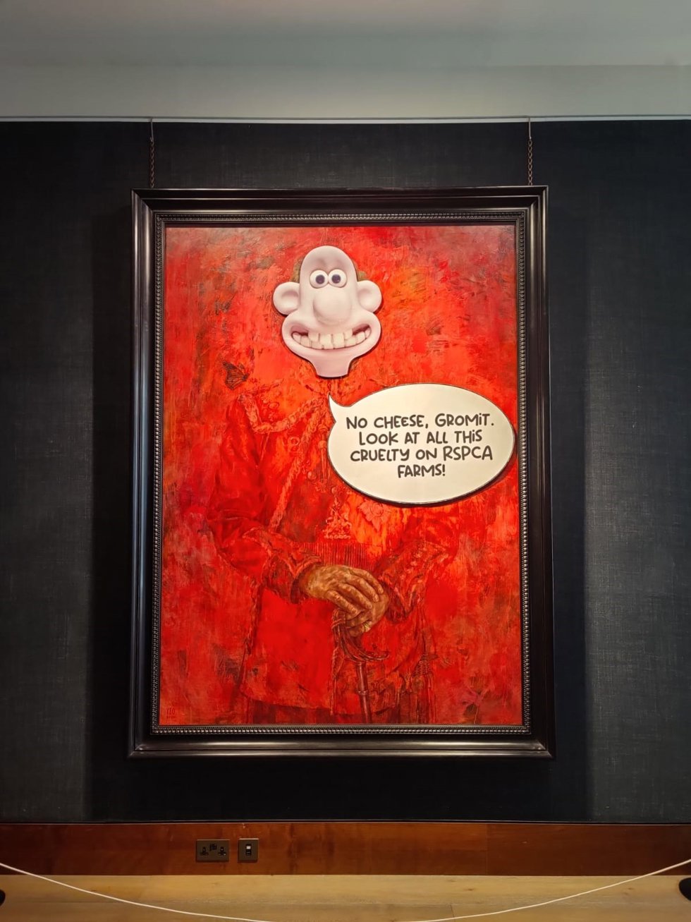 Activistas animalistas vandalizan el retrato oficial del rey Carlos de Inglaterra con una imagen de 'Wallace y Gromit'