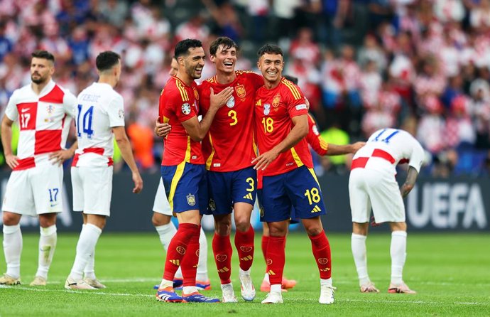 15 June 2024, Berlin: (L-R) Spain's Mikel Merino, Robin Le Normand and Martin Zubimendi celebrate after the UEFA Euro 2024 group B soccer match between Spain and Croatia at the Olympiastadion. Photo: Andreas Gora/dpa