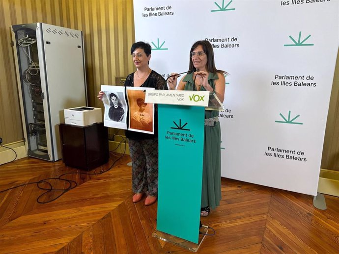 La portavoz parlamentaria de Vox, Manuela Cañadas, y la portavoz adjunta, Maria José Verdú, sosteniendo los carteles.