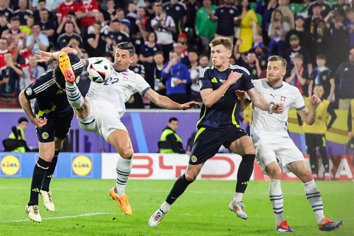 19 June 2024, North Rhine-Westphalia, Cologne: Scotland's Grant Hanley (l) and Switzerland's Fabian Schaer fight for the ball during the UEFA Euro 2024 Group A soccer match between Scotland and Switzerland at Cologne Stadium. Photo: Rolf Vennenbernd/dpa