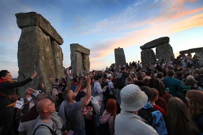 June 20, 2024, Salisbury, England, UK: People gather to celebrate the summer Solstice amongst the stones as the sun sets at Stonehenge. Stonehenge was built by early Britons some 4000 years ago to align with the sun on the solstices. The summer solstice m