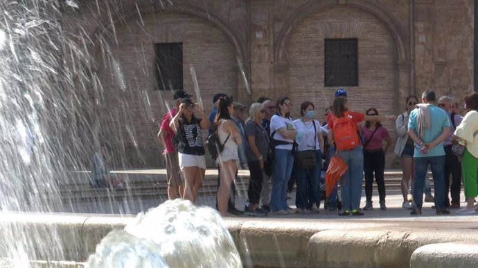 Archivo - Imagen de archivo de una guía turística junto a turistas en el centro de València. 