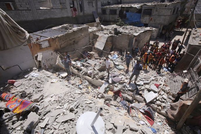 June 18, 2024, Nuseirat, Gaza Strip, Palestinian Territory: Palestinians search the rubble of the al-Madhoun family home following overnight Israeli strikes in the Nuseirat refugee camp in the central Gaza Strip, on June 18, 2024, amid the ongoing  Israel