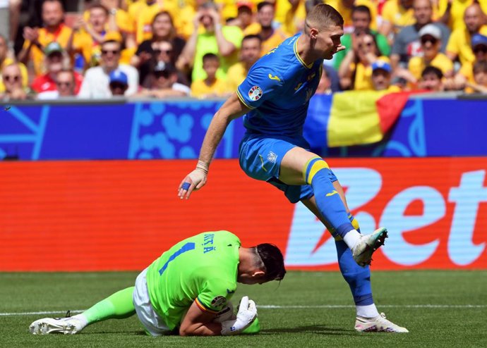 17 June 2024, Bavaria, Munich: Romania goalkeeper Florin Nita (L) clears the ball in front of Ukraine's Artem Dowbyk during the UEFA Euro 2024 group E soccer match between Romania and Ukraine at the Munich Football Arena. Photo: Peter Kneffel/dpa