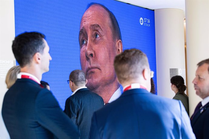 June 7, 2024, St. Petersburg, Russia: Forum visitors seen in front of a screen with a live broadcast from the congress hall of the Expoforum Exhibition and Convention Center where a plenary meeting with Russian President Vladimir Putin is taking place as 