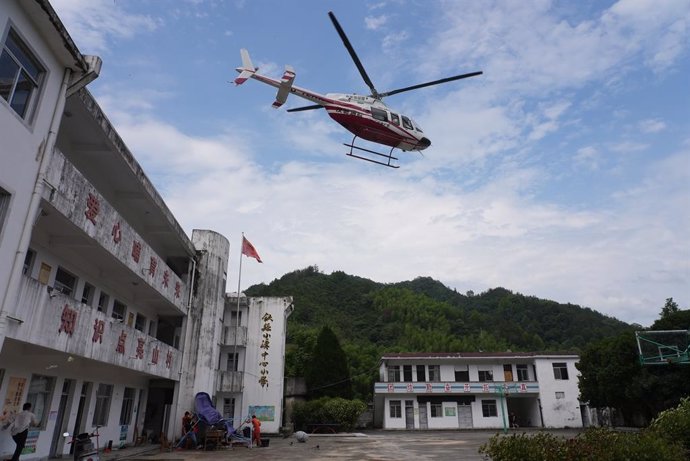 SHEXIAN, June 21, 2024  -- A helicopter carrying supplies prepares to land at a primary school of Shaolian Township in Shexian County, east China's Anhui Province, June 21, 2024. Continuous rainfall has impacted many parts of eastern and southern China, c