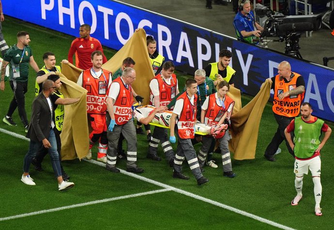 23 June 2024, Baden-Wuerttemberg, Stuttgart: Hungary's Barnabas Varga is taken from the pitch on a stretcher following a collision during the UEFA Euro 2024 group A soccer match between Scotland and Hungary at the MHPArena. Photo: Bradley Collyer/PA Wire/