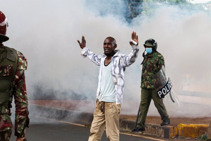 June 20, 2024, Nairobi, Kenya: A protester raises hands to surrender after police fired teargas, during a demonstration against a controversial finance bill in the central business district. Kenyan police used teargas and a water cannon to disperse protes