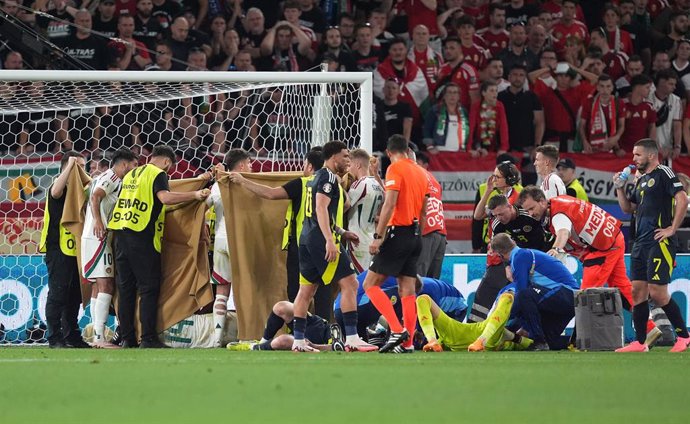 23 June 2024, Baden-Wuerttemberg, Stuttgart: Hungary's Barnabas Varga receives treatment following a collision during the UEFA Euro 2024 group A soccer match between Scotland and Hungary at the MHPArena. Photo: Martin Rickett/PA Wire/dpa