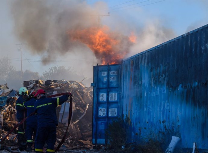 June 19, 2024, Koropi, Eastern Attica, Greece: Firefighters attempt to extinguish the fire that has broke out in a factory area during a wildfire in the eastern suburbs of the Greek capital. Authorities have urged residents to evacuate an area on the frin