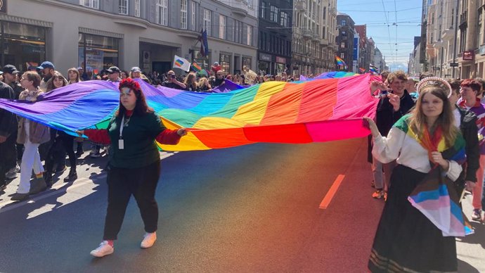 Archivo - 03 June 2023, Latvia, Riga: Participants of the Riga Pride parade with a huge rainbow flag through the city center. Photo: Alexander Welscher/dpa