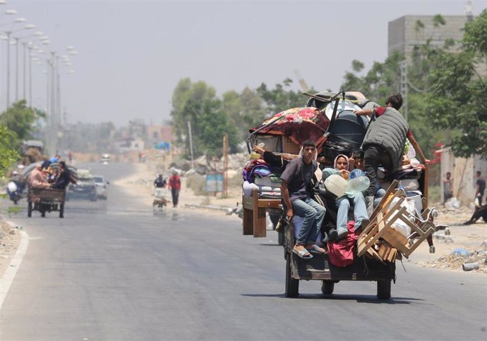 July 2, 2024, Khan Yunis, Gaza Strip, Palestinian Territory: Palestinians, who fled the eastern part of Khan Younis after they were ordered by Israeli army to evacuate their neighborhoods, ride on a vehicle loaded with belongings, amid ongoing Israel war 