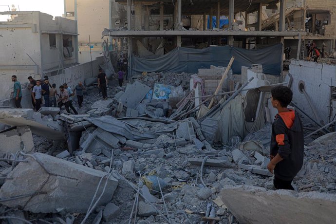 GAZA, July 3, 2024  -- People inspect a destroyed building after an Israeli airstrike in the southern Gaza Strip city of Khan Younis, on July 3, 2024. Dozens of Palestinians were injured on Wednesday when an Israeli airstrike targeted a residential house 