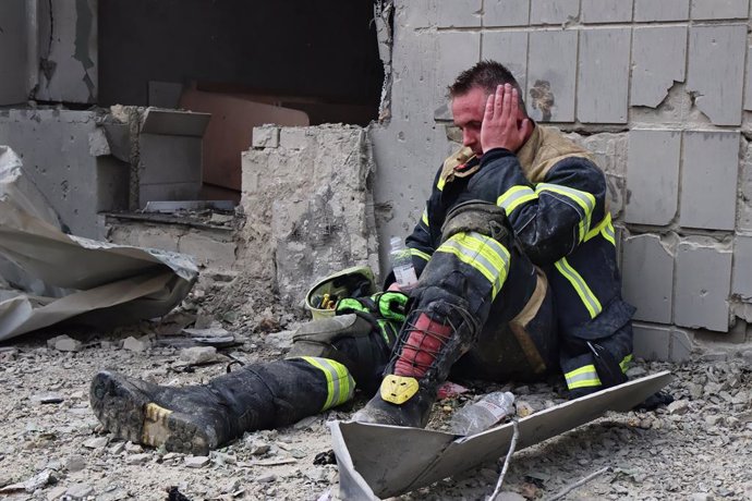 July 8, 2024, Kyiv, Ukraine: A tired firefighter sits near the Okhmatdit Children's Clinic, which was damaged after a rocket attack. In the morning, the Russian army carried out a mass missile attack on the Ukrainian cities of Kyiv, Dnipro, Kryvyi Rih, Sl