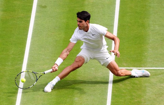 14 July 2024, United Kingdom, London: Spanish tennis player Carlos Alcaraz plays a forehand return to Serbia's Novak Djokovic during their men's singles final tennis match on day fourteen of the 2024 Wimbledon Championships at the All England Lawn Tennis 