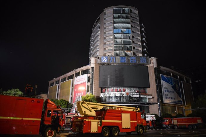 ZIGONG, July 18, 2024  -- This photo taken on July 18, 2024 shows firefighting vehicles at the site of a department store fire in Zigong City, southwest China's Sichuan Province. The rescue operation at the site of the department store fire in Zigong City