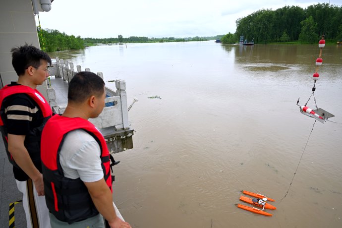 FUNAN, July 14, 2024  -- Staff members monitor the flood water at a hydrological station in Funan County of Fuyang, east China's Anhui Province, July 14, 2024. Measures including monitoring the flood water, inspecting embankment and ensuring flood-control