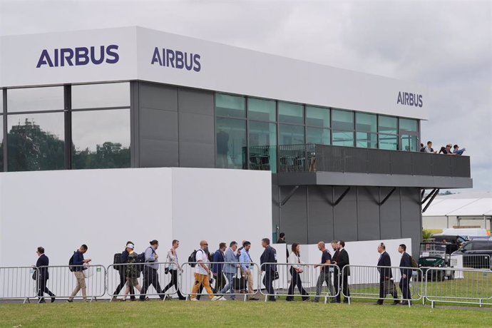 22 July 2024, United Kingdom, Farnborough: People walk past the Airbus building at the Farnborough International Airshow. Photo: Jonathan Brady/PA Wire/dpa