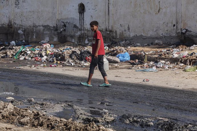 July 23, 2024, Dair El_balah, Gaza Strip, Palestinian Territory: Palestinians walks near tents used as shelter along a street covered with stagnant wastewater in Deir el-Balah in the central Gaza Strip on July 22, 2024. Polio has been detected in samples 