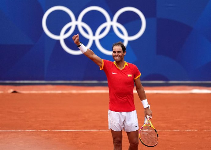 30 July 2024, France, Paris: Spanish tennis players Rafael Nadal and Carlos Alcaraz (not pictured) celebrate victory over Netherlands' Tallon Griekspoor and Wesley Koolhof (not pictured) during the men's doubles second-round match at Roland-Garros on th