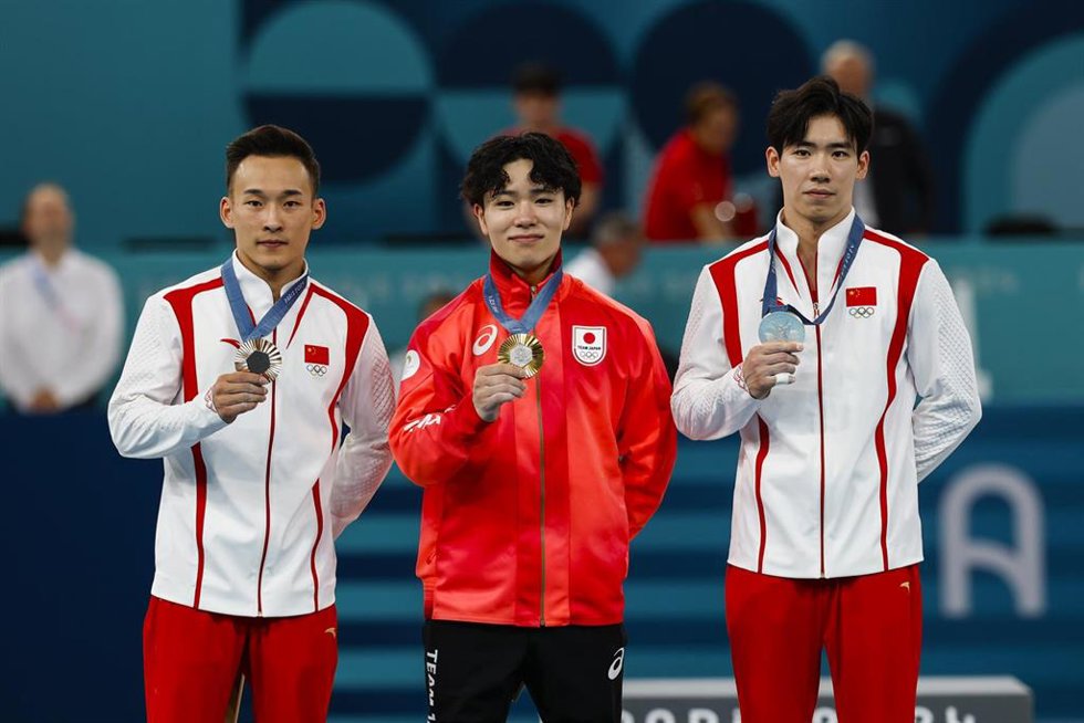 Silver medalist Boheng Zhang of China, Gold medalist Shinnosuke Oka of Japan and Bronze medalist Ruoteng Xiao of Team China pose with their medals on the podium during Men's All-Around Final of the Artistic Gymnastics on Bercy Arena during the Paris 202