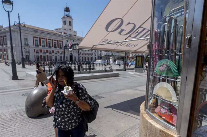 Archivo - Una mujer con un helado en la Puerta del Sol