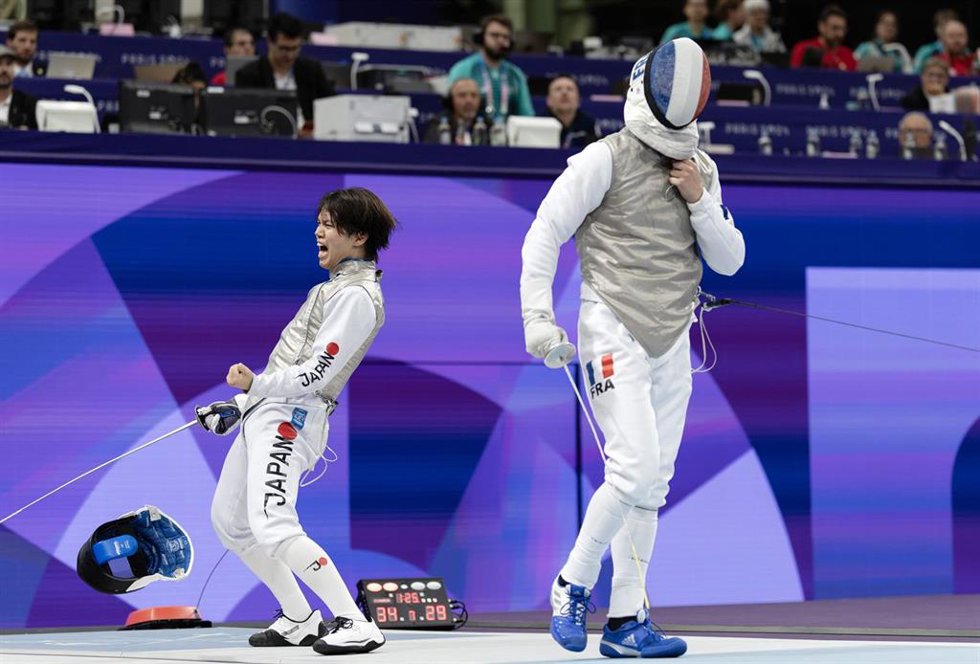 PARIS, Aug. 4, 2024  -- Iimura Kazuki (L) of Japan celebrates scoring while competing against Maximilien Chastanet of France during the men's foil team semifinal 1 of fencing between Japan and France at the Paris 2024 Olympic Games in Paris, France, Aug