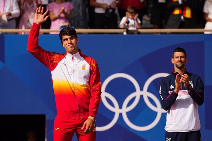 Carlos Alcaraz of Spain and Novak Djokovic of Serbia pose on the podium during the Tennis Men's Singles medal ceremony after the Men's Singles Gold medal match on Court Philippe-Chatrier at Roland-Garros Stadium during the Paris 2024 Olympics Games